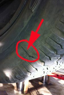 The tire pressure became so low that the sidewall ripped open.