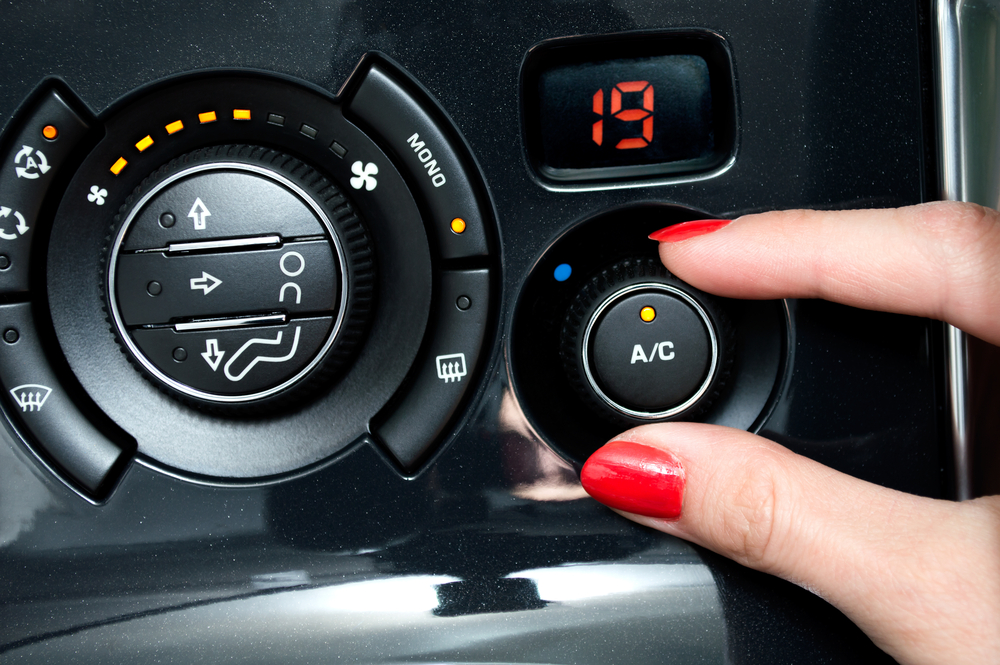 woman-hand-turning-on-air-conditioning-in-car